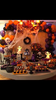 a table filled with halloween treats and decorations