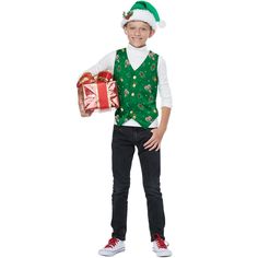 a young boy in a green vest holding a present