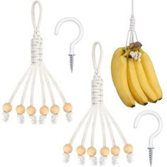 three bananas hanging from hooks and one banana on a white hook with several balls attached to it