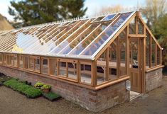 a small greenhouse built into the side of a brick building