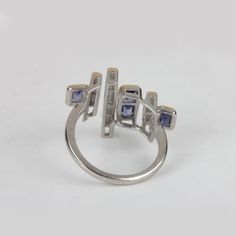 ⚫ This Ring Made With Tanzanite & Diamonds in & 925 Sterling Silver, ⚫ Pave Diamond Gemstone Ring 925 Sterling Silver Jewelry. ⚫ Gemstone Ring, Diamond Ring, Designer Ring, Everyday Jewelry ⚫ Special customize for Mother day, Anniversary, Birthday Gift, Valentine, Christmas. ⚫ Item Details: Gross Weight:4.16 Grams 925 Sterling Silver Weight:3.86 Grams Diamond Weight:0.6 Carats Tanzanite Weight:0.9 Carats Item Size: US 7 (20x23 MM) Item SKU: AROS-1352 Gemstone color may vary due to natura White Gold Sterling Silver Channel Set Sapphire Ring, Modern Silver Sapphire Ring With Accent Stones, Sterling Silver Multi-stone Ring In White Gold Color, Sterling Silver Multi-stone White Gold Rings, Sterling Silver Multi-stone Ring, Modern Silver Sapphire Ring In 14k White Gold, Modern Silver Sapphire Ring For Anniversary, Modern Sterling Silver Sapphire Ring, Modern Sterling Silver Diamond Ring With Accent Stones