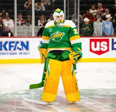 an ice hockey goalie stands on the ice