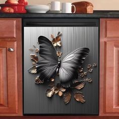 a black and gold butterfly on a metallic refrigerator