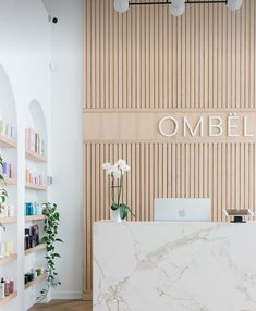 a marble counter in front of a wooden wall with the word ombel on it