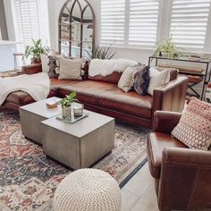 a living room filled with lots of furniture and decor on top of a carpeted floor