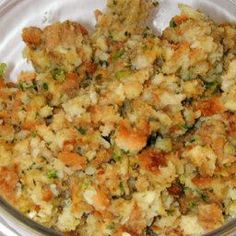 a glass bowl filled with stuffing and vegetables