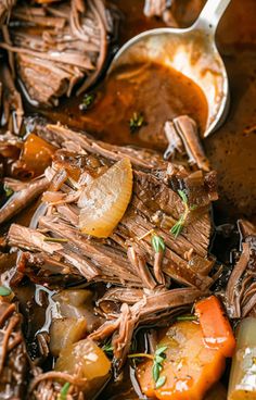 a pot roast with carrots, potatoes and gravy