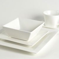 white dishes and cups are stacked on top of each other