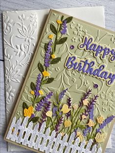 a birthday card with flowers on it and a white fence in the background that says happy birthday