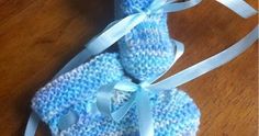 two blue knitted baby booties tied together