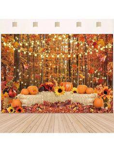 an autumn scene with pumpkins and sunflowers on a table in front of a backdrop