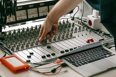 a person is working on an electronic sound board