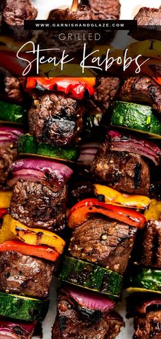 grilled steak kabobs with peppers and onions on a white platter for grilling