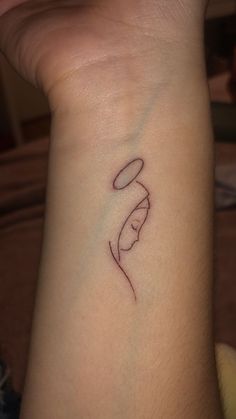 a woman's wrist with a small tattoo on it