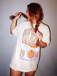 Show the love for your favorite team in this Phoenix, Arizona basketball oversized tshirt that is inspired by vintage 90s N B A tshirts!- Features Phoenix Basketball across the top with a basketball hoop and 1968 with Phoenix, Arizona underneath all in a periwinkle and orange ink- Screen print transfer that is heat pressed onto each tshirt- Tshirt is a super soft vintage wash that gets softer after each wash- Oversized fit- Sizing translation: XS/S = L , S/M = XL , L/XL = 2XL , 2XL/3XL = 3XL- 100% Cotton**due to screens & filters color may vary from pictures** Periwinkle And Orange, Phoenix Basketball, Phoenix Suns Basketball, Suns Basketball, Screen Print Transfer, Print Transfer, Oversized Graphic Tee, Basketball Shirts, A Basketball