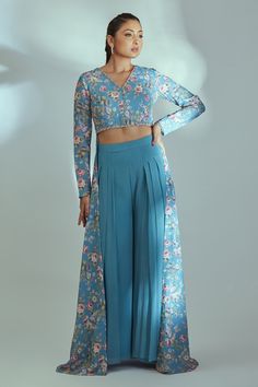 Blue crop top with floral patterns, intricately hand embroidered highlights and back gown style long flare. Comes with flared pant.
Component: 2
Pattern: Embroidered
Type Of Work: Floral Pattern
Neckline: V-Neck
Sleeve Type: Full
Fabric: Georgette and Crepe
Color: Blue
Other Details: 
Shantoon lined front crop top and pant
Back gown like flare
Back cut-out
Pleated accents on pant
Occasion: Mehendi and Haldi - Aza Fashions Top And Plazo, Low Crop Top, Silk Anarkali, Anarkali Lehenga, Cutout Gown, Hacks Clothes, Unique Dress, Floral Gown, Stitch Ideas