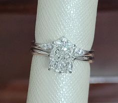 a diamond ring sitting on top of a white napkin