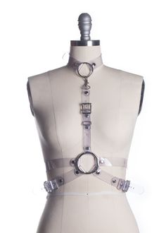 "She's dead... wrapped in plastic". This clear PVC wrap style harness is inspired by Laura Palmer in Twin Peaks. Fit is adjustable at front and sizes with buckles. Detachable choker collar can be worn separately. Also available in vegan leather or leather. Silver-toned nickel plated steel hardware. All pieces are MADE TO ORDER, standard sizes XS-4XL. If your measurements fall outside these standards or you are unsure of what size to order, select "CUSTOM" and include your measurements in the not Adjustable Strapped Harness For Cosplay, Adjustable Edgy Harness For Cosplay, Adjustable Belt Harness For Cosplay, Adjustable Strapped Harness For Party, Adjustable Strapped Party Harness, Adjustable Party Harness, Edgy Adjustable Harness With Belt, Edgy Adjustable Strapped Harness, Adjustable Punk Harness For Parties