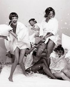 four women in white bathrobes posing for the camera with their mouths wide open