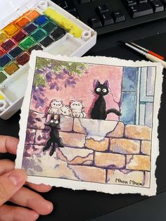 a person holding up a card with cats on it