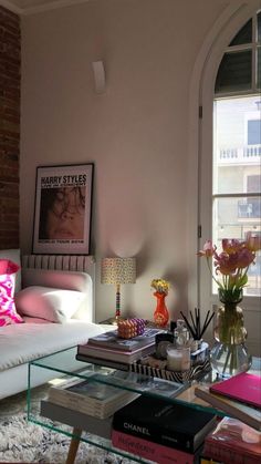 a living room filled with lots of furniture and flowers on top of a glass table