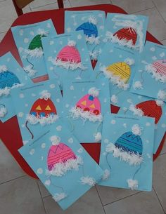 some paper bags with hats on them sitting on a red table and white tile floor