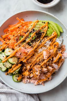 salmon sushi bowls with carrots and cucumbers