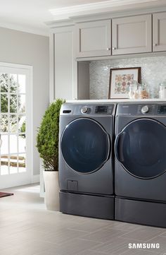 the front load washer and dryer are sitting next to each other in this kitchen