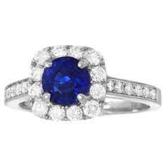 Circa 2000s, 14k, American. Surrounded by .60 carats of fine white diamonds (G color and VS clarity), the main drama of this ring is the vivid 1.55-carat royal blue sapphire. Stunning from every angle, this ring is a perfect never-take-it-off jewel. Meticulously fabricated, it is in excellent condition. Remark: "Sapphire and diamond are the perfect pairing.” SIZE: 7 1/4, it can be sized. WEIGHT: 3.5 grams STONES: 1.55-carat fine sapphire and .60-carats total weight of diamonds HALLMARKS: 14k, 58