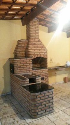 an outdoor brick oven in the middle of a kitchen