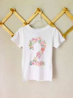 Floral themed birthday girls, floral second birthday, floral birthday shirt, watercolor floral number shirt CHOOSE ANY NUMBER! This shirt is a great option for your little doll's floral themed birthday. Sizes available: 6-12M bodysuit 12-18M Bodysuit 12-18M Tshirt 2T Tshirt 3T Tshirt 4T Tshirt 5T Tshirt 6T Tshirt 7T Tshirt 8T Tshirt Spring First Birthday Top With Short Sleeves, Pink Top For First Birthday In Spring, Pink Tops For First Birthday In Spring, Spring Short Sleeve Top For First Birthday, Half Birthday Baby, Toddler Easter Shirt, Girls Birthday Shirt, Baby Boy Easter, Easter Shirts For Boys