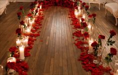 a room filled with lots of candles and red roses on the floor next to each other