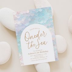 a birthday card with the words under the sea on it next to some white rocks