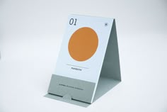 a white and orange business card holder