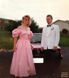 a man and woman standing next to a car