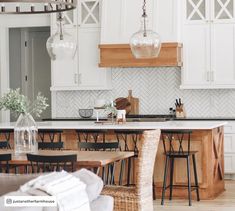 the kitchen is clean and ready to be used for cooking or dining room furniture, as well as an island with stools