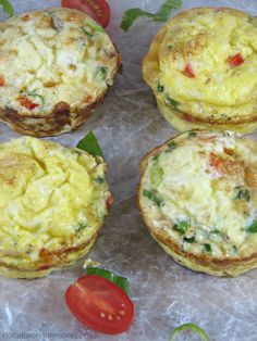 four small muffins with cheese and vegetables on top