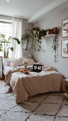 a bed room with a neatly made bed and plants