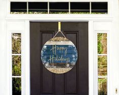 a happy holidays sign hangs on the front door