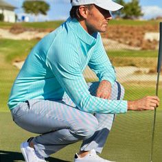 a man kneeling down with a golf club in his hand