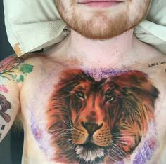 a man's chest with a lion tattoo on it