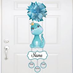 a door hanger with a blue dragon on it's head and name in the center