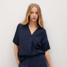 Flowy Fabric. Oversize Design. V-Neck. Lapel-Collar. Short Sleeve. Dropped Shoulder Seams. Composition: 87% Viscose,13% Polyester Blue V-neck Blouse For Office, Versatile V-neck Viscose Blouse, Chic V-neck Blouse With Relaxed Fit, Chic V-neck Relaxed Fit Blouse, Oversized Versatile V-neck Blouse, Versatile Oversized V-neck Blouse, Versatile Blue Blouse For Work, Versatile Blue Blouse For Workwear, Blue V-neck Blouse For Work