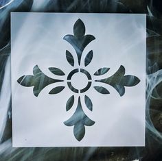 a white paper with a black and gray flower design on it's back side