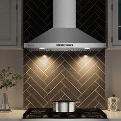 a stove top oven sitting inside of a kitchen next to white cupboards and drawers