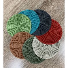 four round rugs with different colors and sizes on a wooden floor in the middle