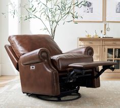 a brown recliner chair sitting on top of a rug