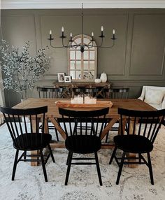 a dining room table with six chairs around it