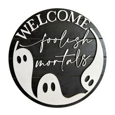 a black and white sign that says, welcome to the halloween season with ghost faces on it