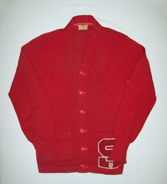 This offering is for an an original circa 1950's letterman sweater. The sweater is made of wool knit and is quite nice being a deep red in color. The original makers tag reads "SPORTCLAD J.C. PENNEY'S CO INC. ALL WOOL SIZE 38 REG US PAT OFF". The sweater features two large front pockets and cats eye buttons. On one pocket is a large letter C. The condition is very nice with no odors and the only hole I see is in the left armpit.  The measurements are a given below taken with the garment laying f Vintage College Sweater For Winter, Vintage College Sweater For Fall, Vintage Sweater For College In Winter, Vintage Sweater For College In Fall, Vintage Winter Sweater For College, Vintage Fall Sweater For College, Vintage Cotton College Cardigan, Vintage Cotton Sweater For College, Vintage Cotton Cardigan For College